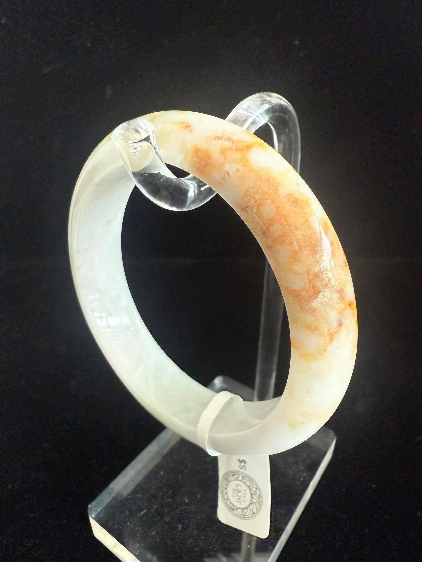98. Brown, orange touches on white green jade bangle