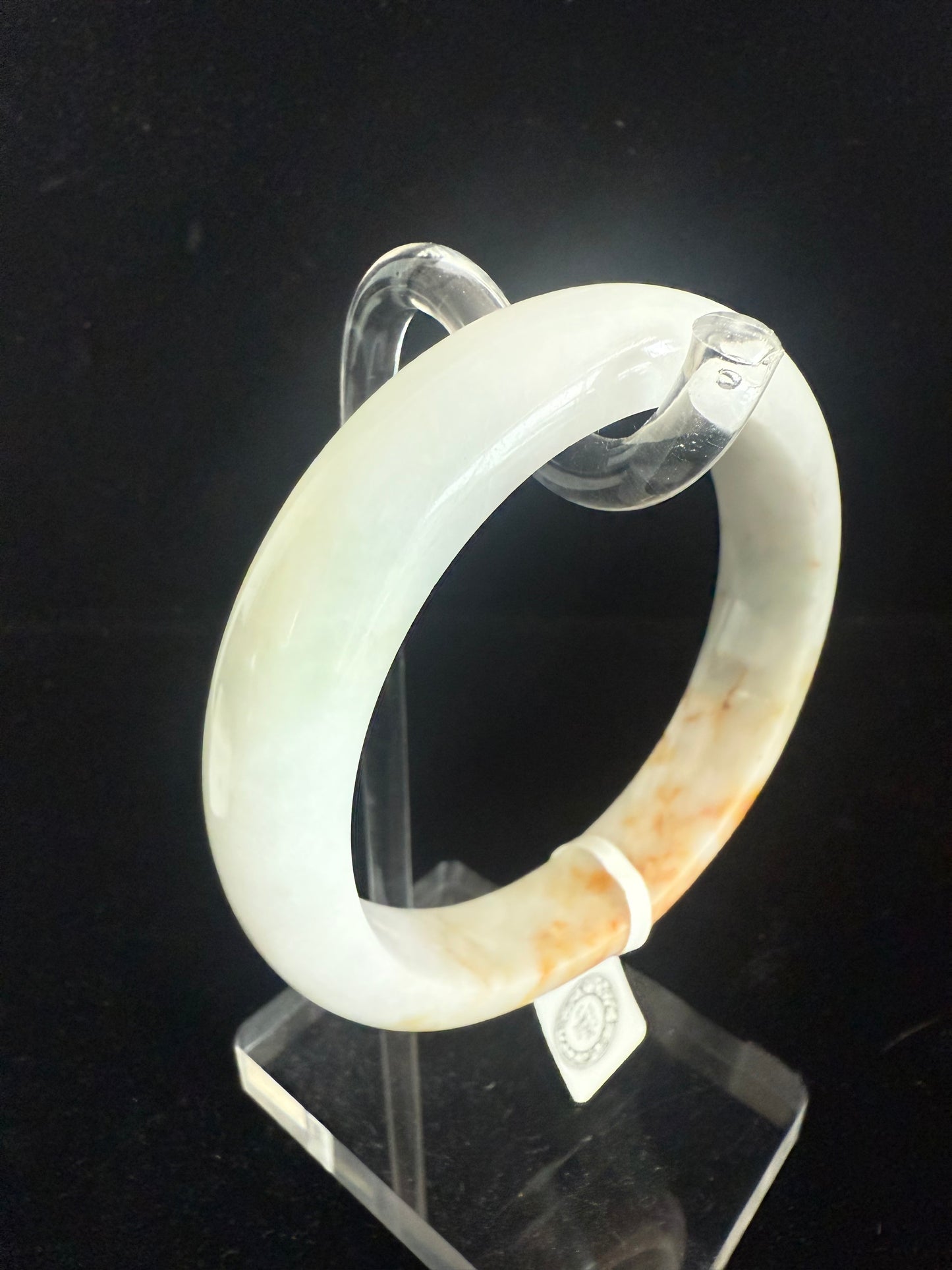 98. Brown, orange touches on white green jade bangle