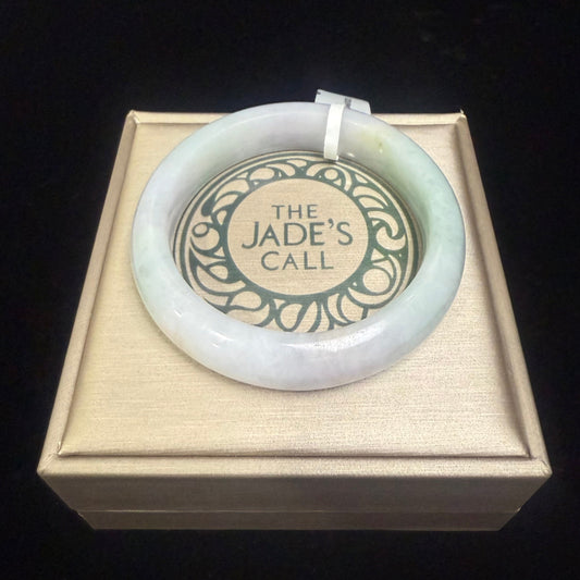 54. A fair green & purple jade bangle