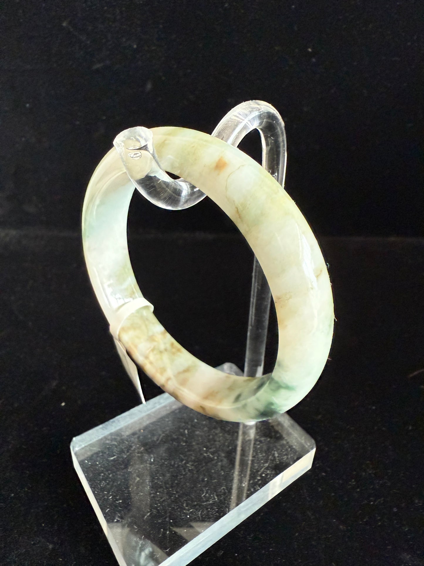 95. Hues of green and yellow brown color jade bangle.