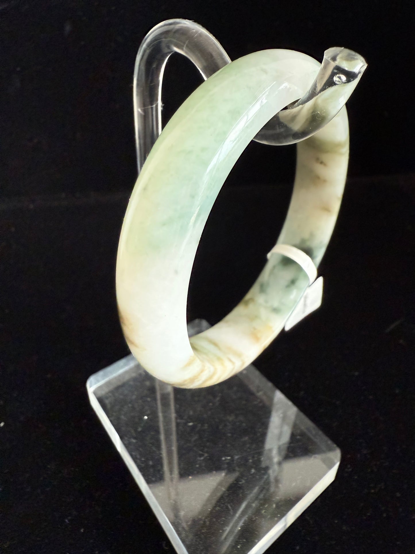 95. Hues of green and yellow brown color jade bangle.