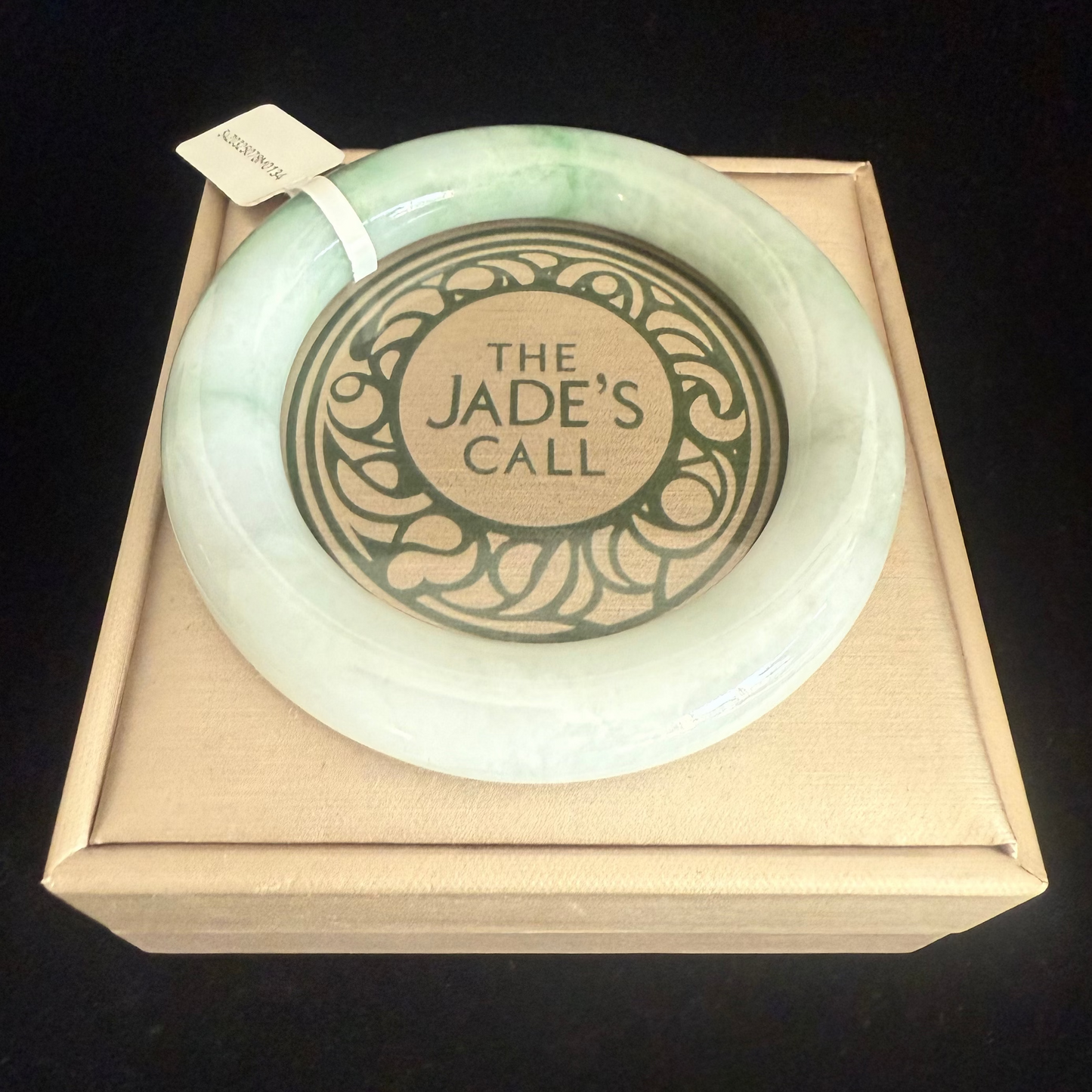 134. Traditional round with swirl of green Jade Bangle