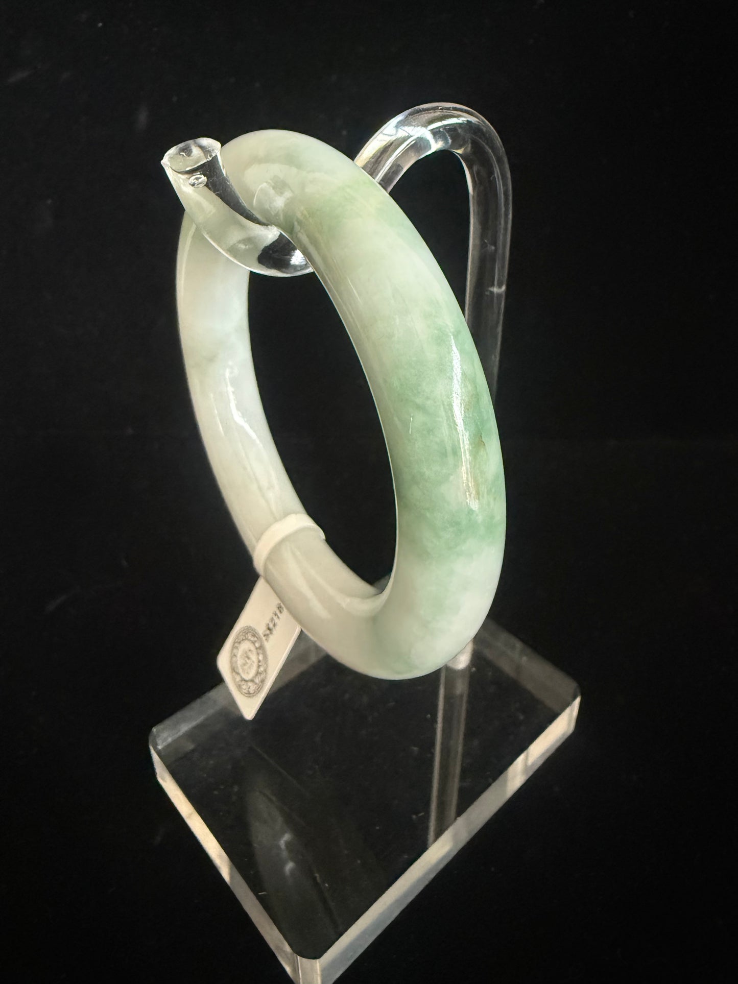 134. Traditional round with swirl of green Jade Bangle