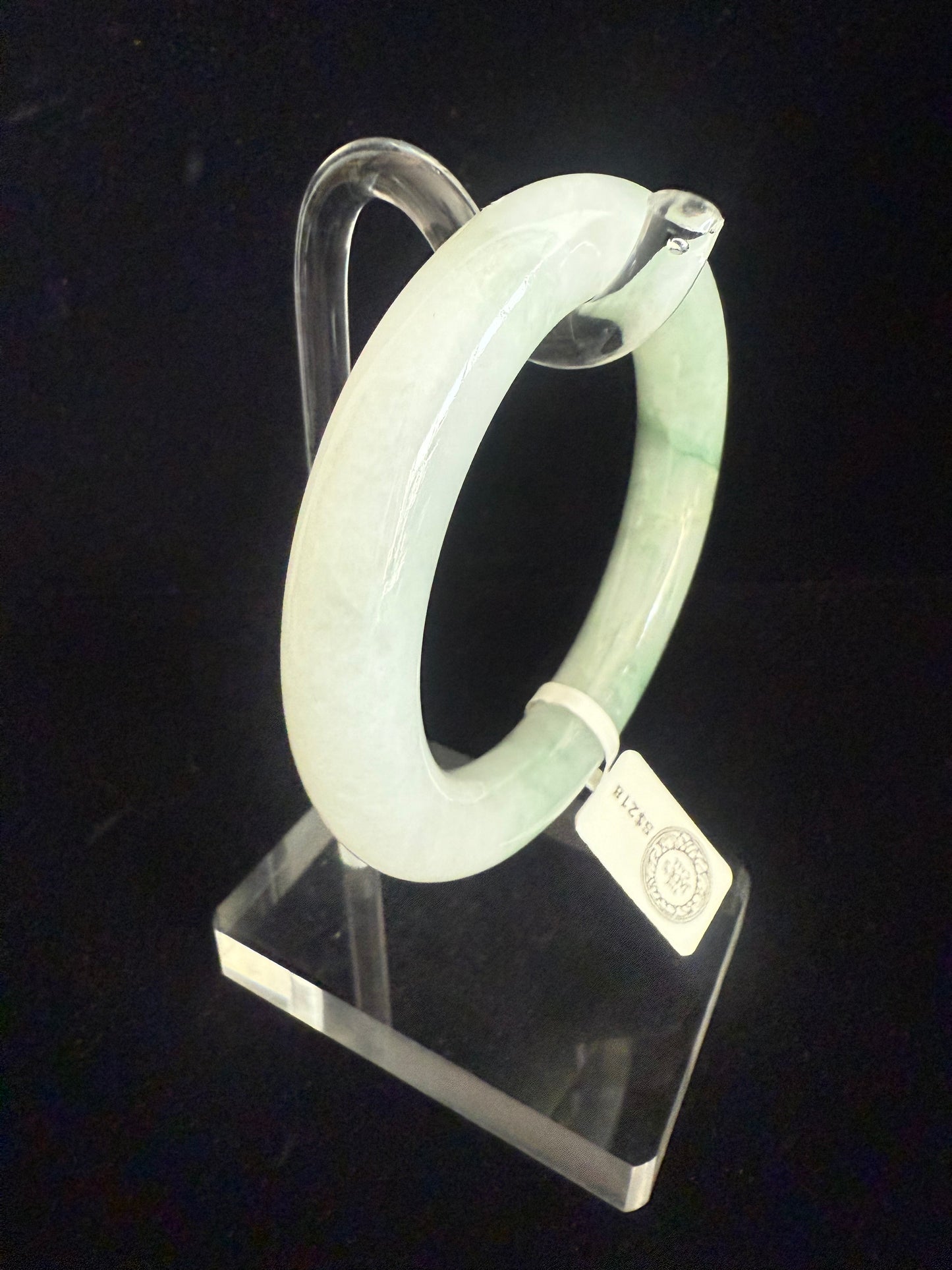 134. Traditional round with swirl of green Jade Bangle