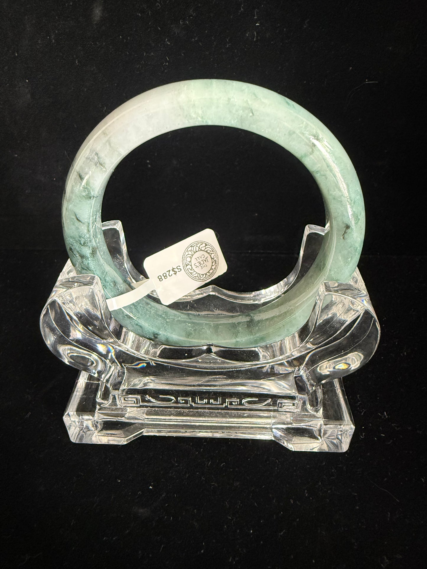 237.  Speckles of dark green and light green blended jade bangle