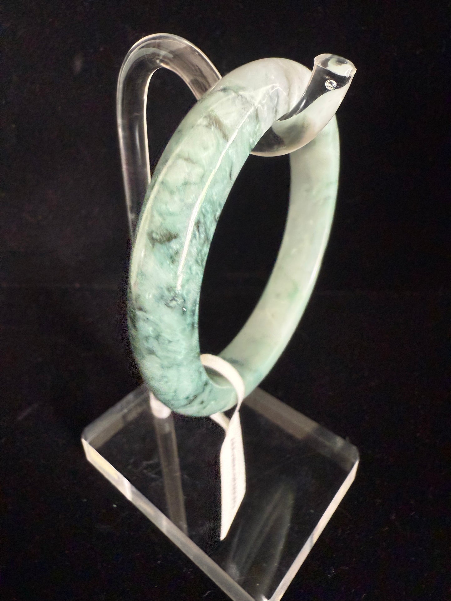 237.  Speckles of dark green and light green blended jade bangle