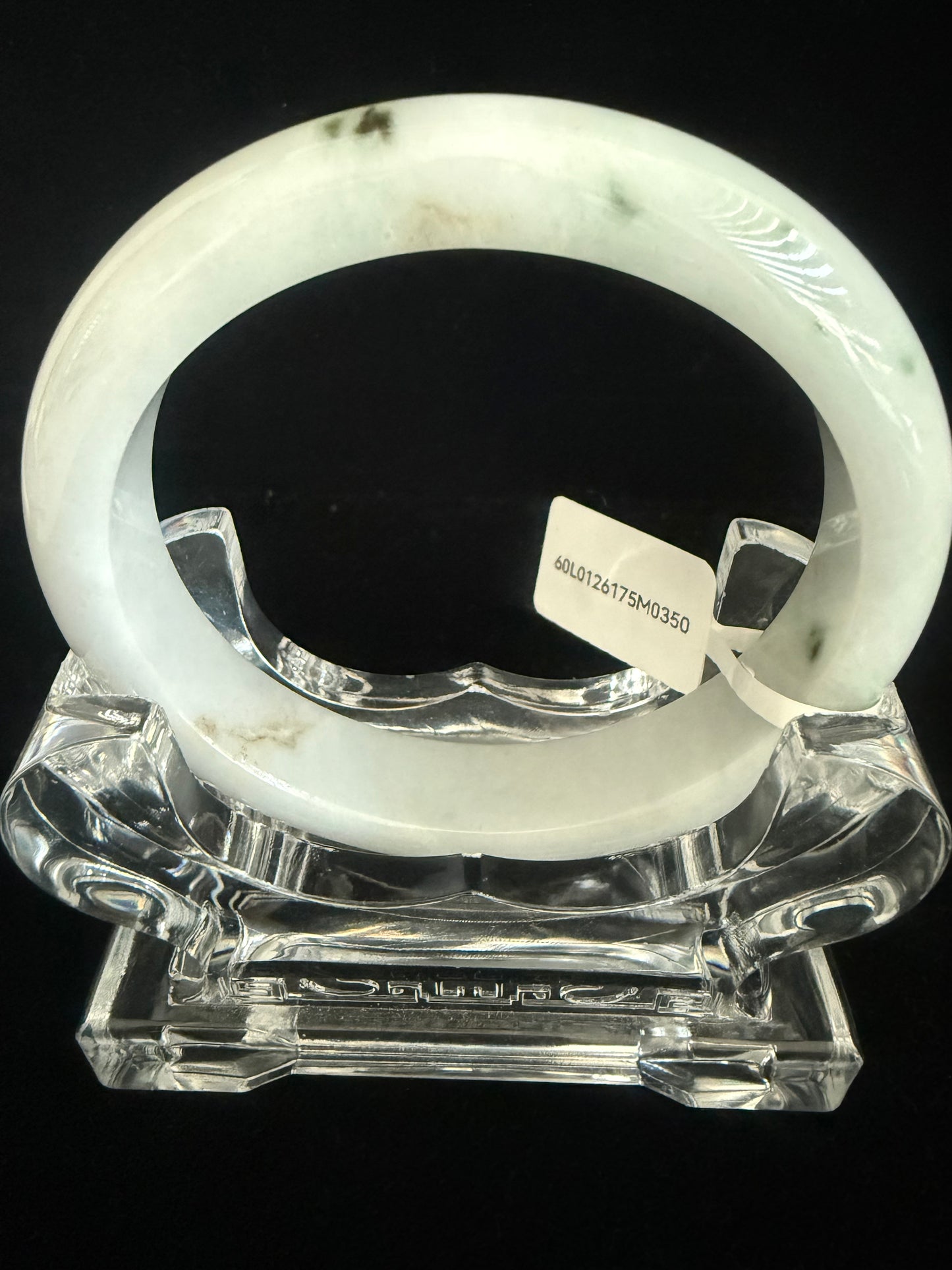 350.  Milky white base with traces of dark green Jade bangle