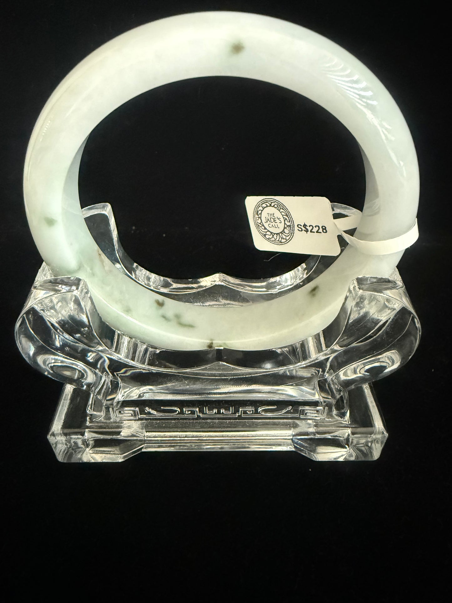350.  Milky white base with traces of dark green Jade bangle
