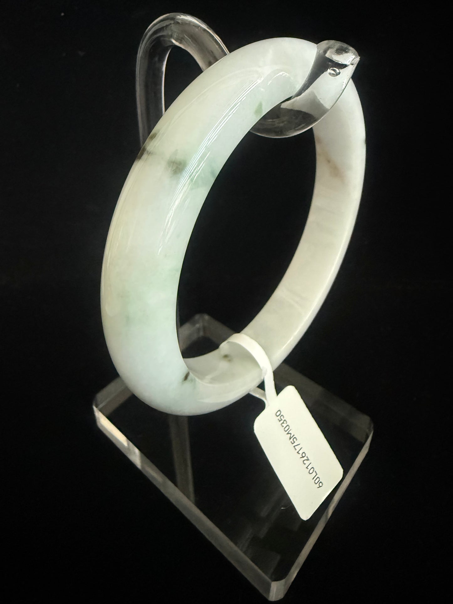 350.  Milky white base with traces of dark green Jade bangle