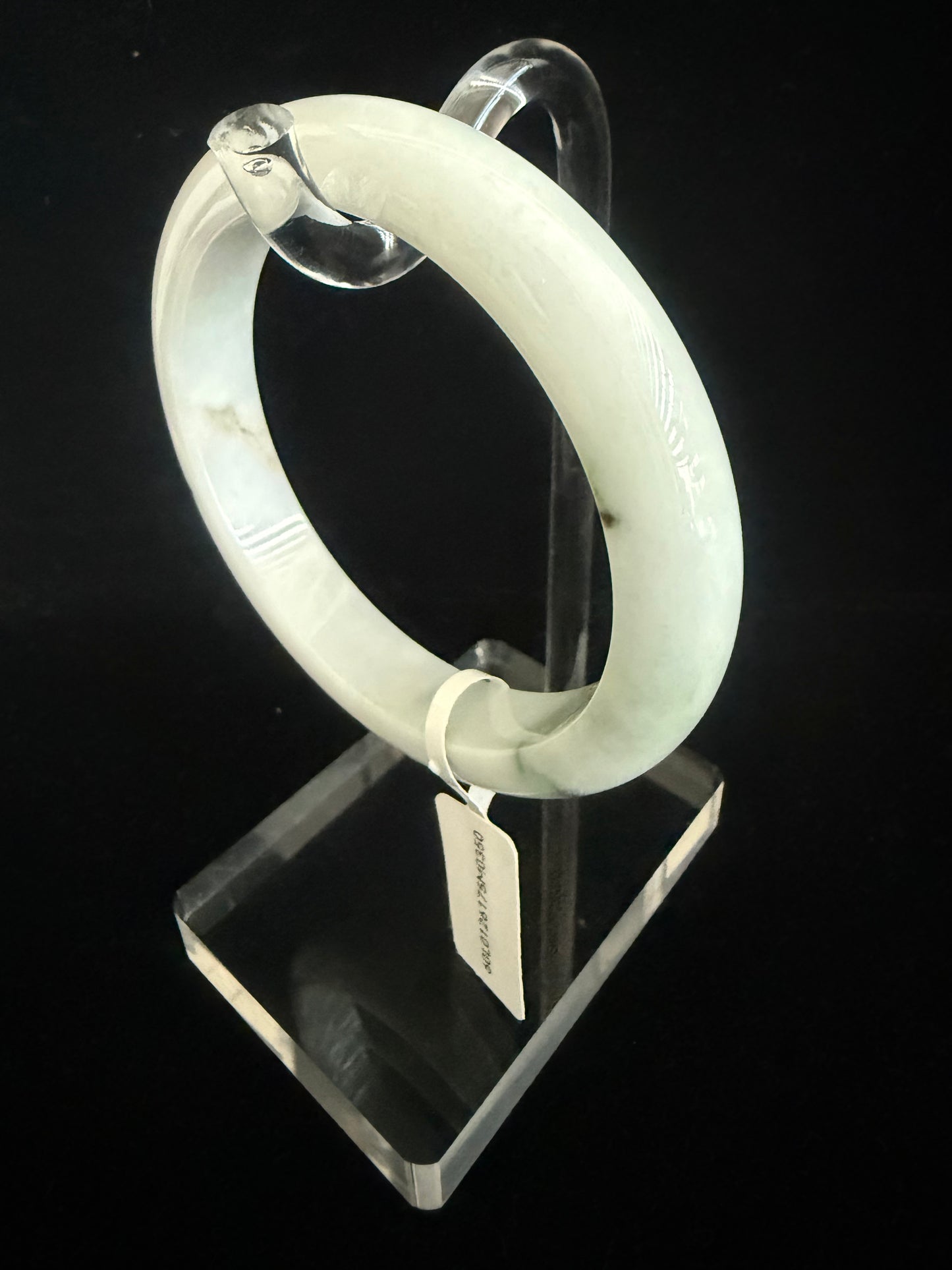 350.  Milky white base with traces of dark green Jade bangle