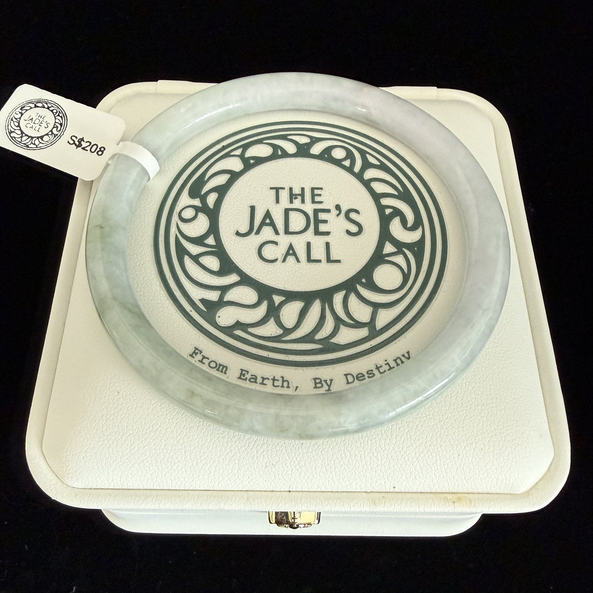 506. Pale celadon with olive mottling thin jade bangle