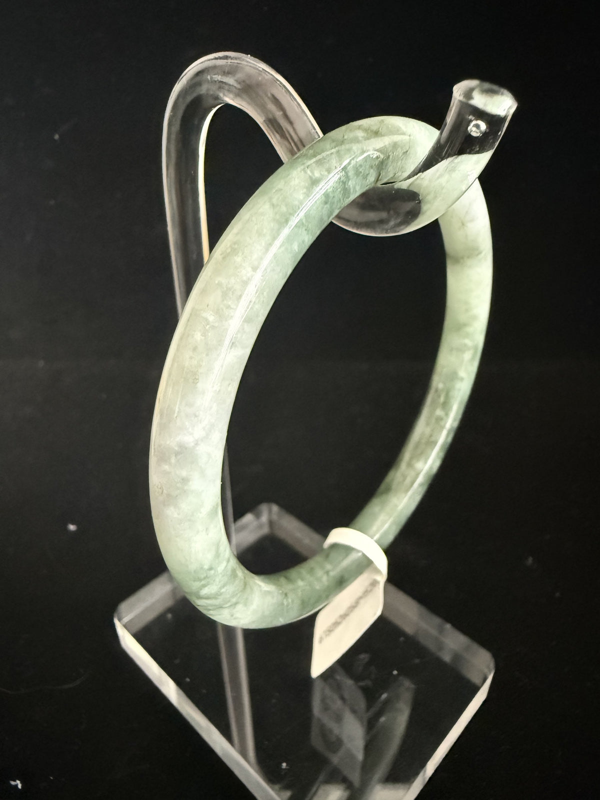 520. Grey-green mottled thin jade bangle
