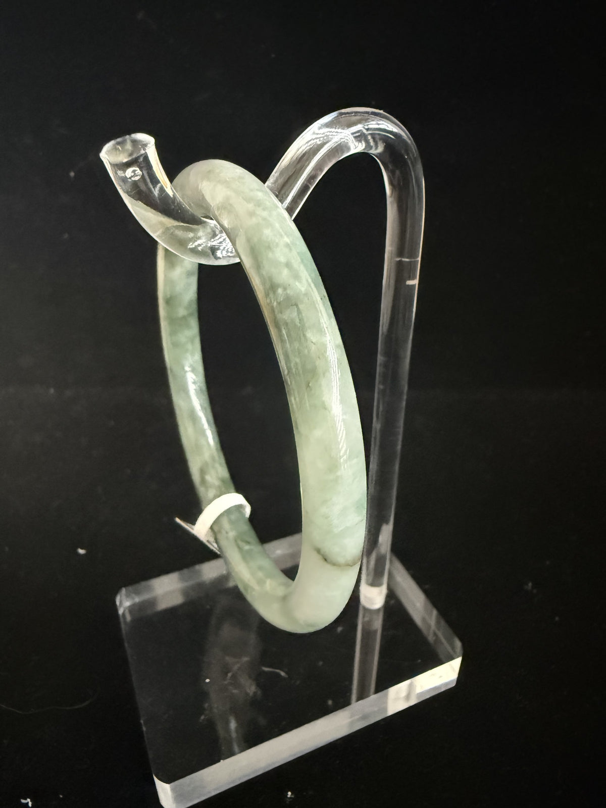 520. Grey-green mottled thin jade bangle